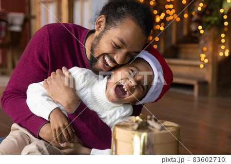 Happy biracial father and small son play at home Happy biracial father and small son play at home 83602710