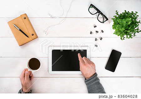 Directly above view of human hands with digital tablet. Directly above view of human hands with digital tablet. 83604028