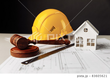 Judge gavel, white house and yellow helmet with drawing tools Judge gavel, white house and yellow helmet with drawing tools 83605621