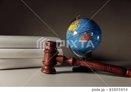 Wooden gavel and globe on the desk. International law and justice court concept 83605654