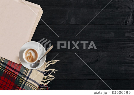 Workspace with newspaper, coffee cup, scarf. Stylish office desk. Autumn or Winter concept. Flat lay, top view 83606599