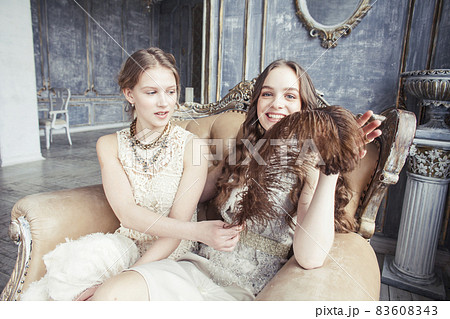 two pretty twin sister blond curly hairstyle...の写真素材