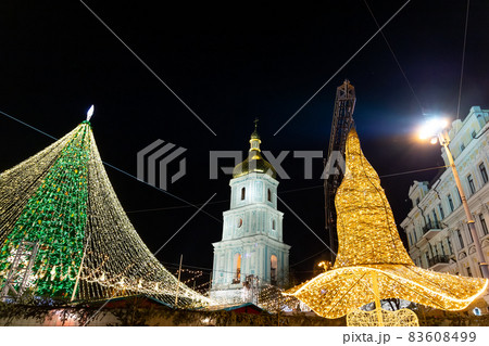 Beautiful scenic decorated Christmas Tree with decorations and illuminated by light garlands against Sophia Cathedral on background Sofievska square market. Happy 2022 New Year and xmas Celebration 83608499