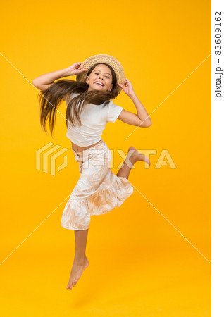 Cheerful small girl summer outfit jumping, energy and motion concept 83609162