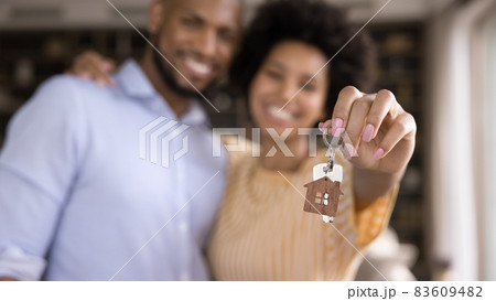 Close up keys in hands of blurred african couple. 83609482