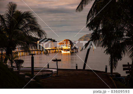 Sunset over wooden beach bar in sea and hut on pier in koh Mak island, Trat, Thailand Sunset over wooden beach bar in sea and hut on pier in koh Mak island, Trat, Thailand 83609593