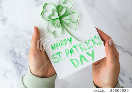 Gift idea, decor Spring, happy Patrick Day. Step by step. Diy St. Patricks Day greeting card made of Quilling and paper clovers on white background. Gift idea, decor Spring, happy Patrick Day. Step by step. Diy St. Patricks Day greeting card made of Quilling and paper clovers on white background. 83609920
