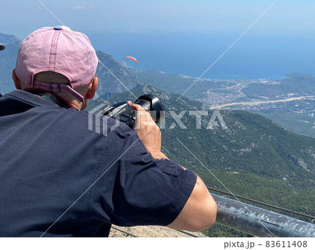 Young photographer in the mountains Young photographer in the mountains 83611408