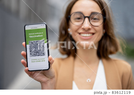 Woman show phone with Coronavirus Vaccination app Woman show phone with Coronavirus Vaccination app 83612119