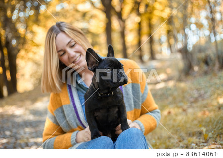 Closeup on happy young woman with dog outdoors in autumn 83614061