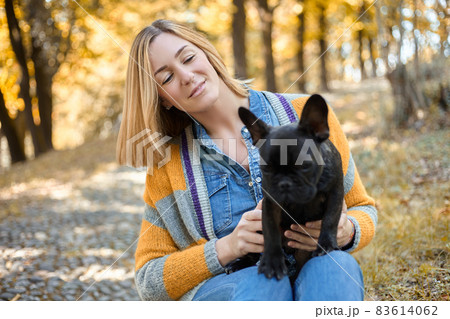Closeup on happy young woman with dog outdoors in autumn 83614062