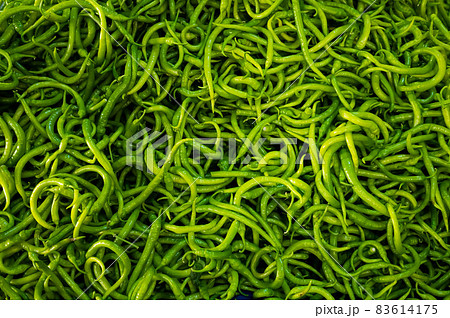 Close-up on a shelf with green peppers in the market. Close-up on a shelf with green peppers in the market. 83614175