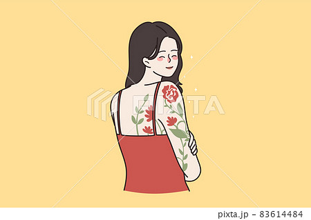 Smiling girl with flower tattoo on shoulder  83614484