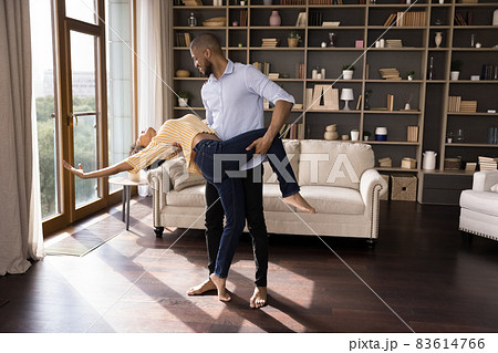 Happy passionate young african american family couple dancing at home. 83614766