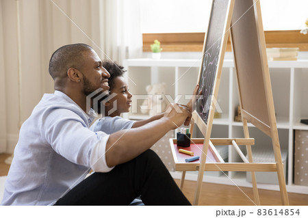 Happy african american family drawing on board. 83614854