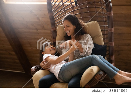 Happy joyful mom tickling, cuddling excited daughter girl Happy joyful mom tickling, cuddling excited daughter girl 83614865