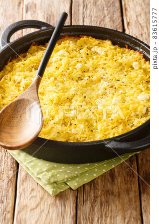 Patatnik is a delicious Bulgarian potato pie with cheese, mint and eggs close-up. Vertical Patatnik is a delicious Bulgarian potato pie with cheese, mint and eggs close-up. Vertical 83615777