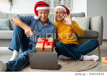 Senior Couple At Laptop Video Calling Celebrating Christmas Distantly Indoor 83616026