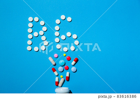 B 6 vitamin pills on a blue background, special treatment for people on diet. 83616386