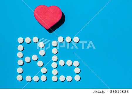 B 6 vitamin pills on a blue background, special treatment for people on diet. 83616388