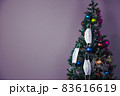 Christmas tree with decoration and face masks as a symbol of coronavirus 83616619