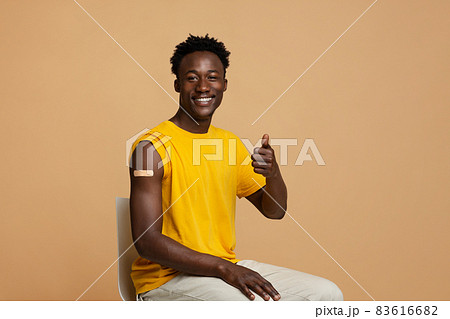 Vaccination Concept. Happy Vaccinated Black Guy Showing Thumb Up At Camera Vaccination Concept. Happy Vaccinated Black Guy Showing Thumb Up At Camera 83616682