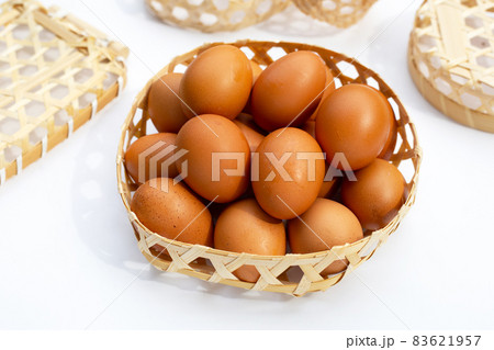 Chicken eggs in bamboo basket on white. Chicken eggs in bamboo basket on white. 83621957