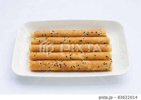 Crispy egg rolls in plate on white background. 83622014