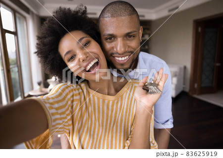 Joyful young african american couple showing keys. Joyful young african american couple showing keys. 83625919