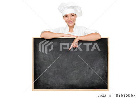 Chef poitnting at menu chalkboard black board with top hat showing today specials at restaurant. Blank empty blackboard for advertising writing text for kitchen food. Isolated on white background. Chef poitnting at menu chalkboard black board with top hat showing today specials at restaurant. Blank empty blackboard for advertising writing text for kitchen food. Isolated on white background. 83625967