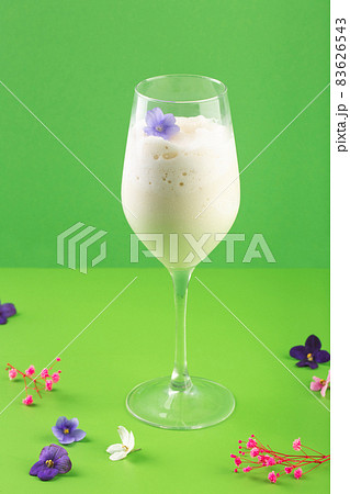 milk shake white cocktail in glass with berries and flowers milk shake white cocktail in glass with berries and flowers 83626543