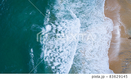 Aerial view sandy beach and waves Beautiful tropical sea in the morning summer season image by Aerial view drone shot, high angle view Top down 83629145