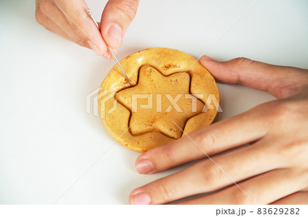 Hands closeup scratch brown sugar caramel candy cookies Hands closeup scratch brown sugar caramel candy cookies 83629282