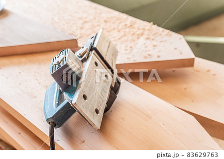 Hand planer over wooden boards. Carpentry factory 83629763
