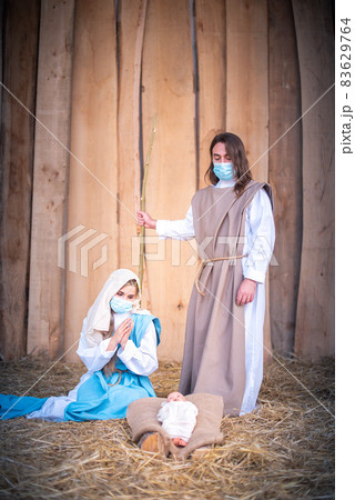 Vertical photo of nativity scene with the characters wearing masks 83629764