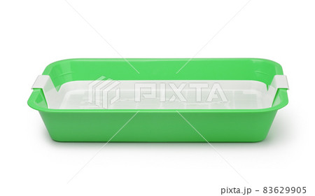 Side view of empty green plastic cat litter tray 83629905