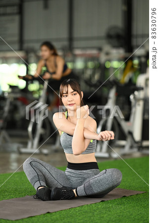 Fitness woman in sportswear  warming up before workout. 83630796