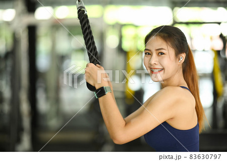 Fitness woman in sportswear exercising in gym and smiling to camera. Fitness woman in sportswear exercising in gym and smiling to camera. 83630797