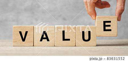 Business man hand holding wooden cube block with Value business word on table background. Mission, Vision and core values concept 83631552