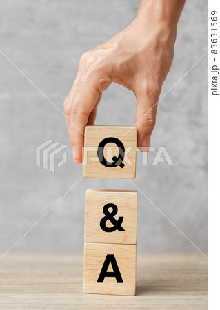 Hand holding Q and A word with wooden block. FAQ( frequency asked questions), Answer, Question  Ask, Information, Communication and Brainstorming Concepts 83631569