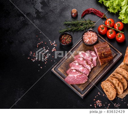 Delicious fresh bacon sliced with bread and vegetables Delicious fresh bacon sliced with bread and vegetables 83632429