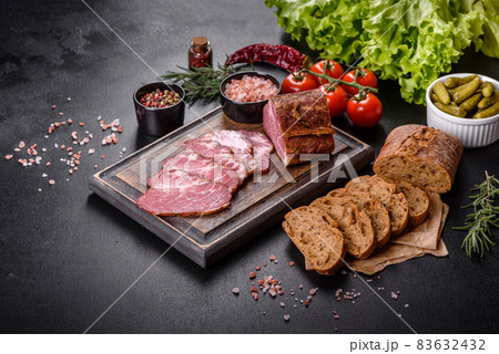 Delicious fresh bacon sliced with bread and vegetables Delicious fresh bacon sliced with bread and vegetables 83632432