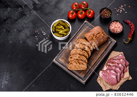 Delicious fresh bacon sliced with bread and vegetables 83632446