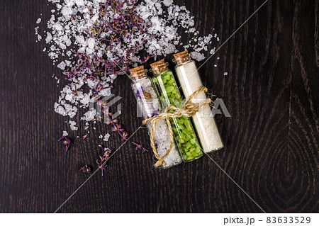 Glass jar with bath salts on black background 83633529