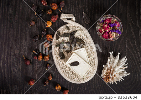 natural soap, dried flowers, sponge and shell on a black background 83633604