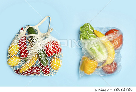 A reusable shopping string bag with vegetables and fruit from the supermarket. Single-use plastic bag ban concept. Zero waste background. High quality photo 83633736