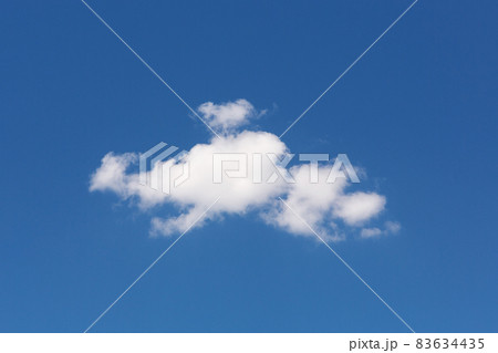 one white cloud of a bizarre shape, against a blue sky 83634435