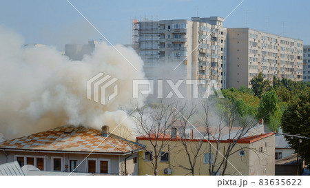 Flames going out from burning house in neighbourhood Flames going out from burning house in neighbourhood 83635622