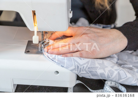 Female hands sewing at home closeup. Female hands sewing at home closeup. 83636168