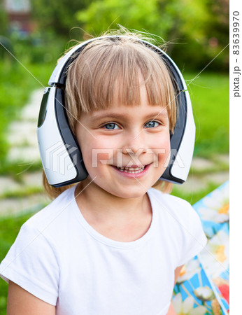 Little girl wearing headphones Little girl wearing headphones 83639970